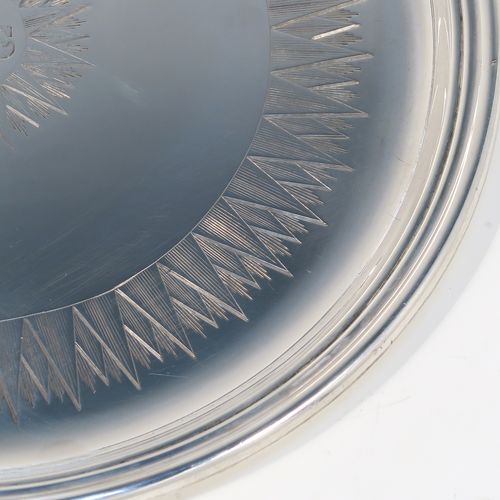 A very handsome Antique early Victorian Sterling Silver offertory or alms dish, having a round body, with an applied reeded border, a hand-engraved ground with sun-burst work surrounding a central Christogram, and all sitting on a flat base. This elegant antique silver alms or offertory dish was made by Henry Wilkinson of Sheffield in 1839. The dimensions of this fine hand-made silver offertory dish are diameter 23 cms (9 inches), and it weighs approx. 475g (15.3 troy ounces).
