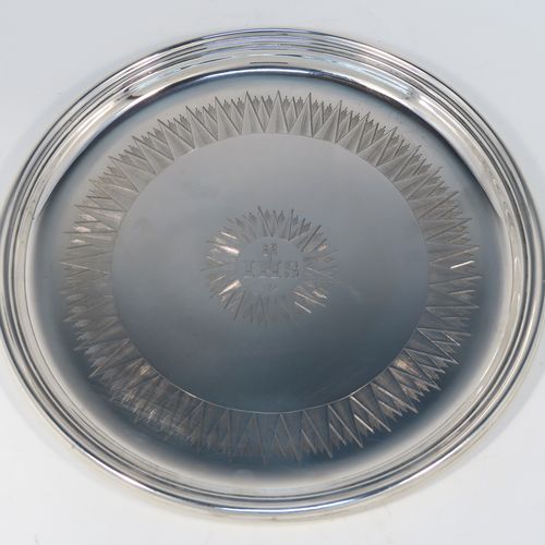 A very handsome Antique early Victorian Sterling Silver offertory or alms dish, having a round body, with an applied reeded border, a hand-engraved ground with sun-burst work surrounding a central Christogram, and all sitting on a flat base. This elegant antique silver alms or offertory dish was made by Henry Wilkinson of Sheffield in 1839. The dimensions of this fine hand-made silver offertory dish are diameter 23 cms (9 inches), and it weighs approx. 475g (15.3 troy ounces).