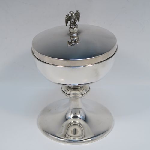 A very handsome Sterling Silver Ciborium, having a plain round body with a gold-gilt interior, sitting on a matching pedestal foot with central baluster, and a lift-off lid with a cast eagle finial. This elegant silver ciborium was made by A. R. Mowbray and Co. Ltd., of London in 1965. The dimensions of this fine hand-made silver ciborium are height 15 cms (6 inches), diameter of cup 11.5 cms (4.5 inches), and the cup weighs approx. 332g (10.7 troy ounces).   