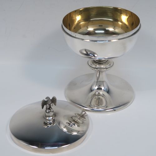 A very handsome Sterling Silver Ciborium, having a plain round body with a gold-gilt interior, sitting on a matching pedestal foot with central baluster, and a lift-off lid with a cast eagle finial. This elegant silver ciborium was made by A. R. Mowbray and Co. Ltd., of London in 1965. The dimensions of this fine hand-made silver ciborium are height 15 cms (6 inches), diameter of cup 11.5 cms (4.5 inches), and the cup weighs approx. 332g (10.7 troy ounces).   