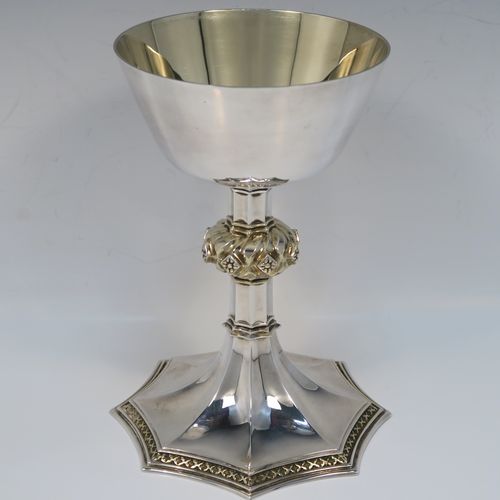 A large and handsome Sterling Silver altar chalice, with a round tapering cup and a gold-gilt interior, an octagonal panelled stem with a central applied jewel-like baluster (which is also gold-gilt), and all sitting on a spreading octagonal panelled base with an applied gold-gilt cross-style border. This beautiful silver altar chalice was made made by Vanpoulles of London in 1975. The dimensions of this fine hand-made silver chalice are height 18 cms (7 inches), diameter at lip of cup 11 cms (4.3 inches), spread across foot 13 cms (5 inches), and it weighs approx. 412g (13.3 troy ounces).  