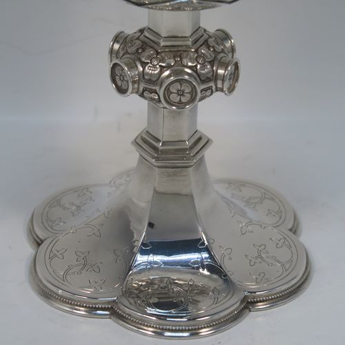 A beautiful Antique Victorian Sterling Silver Ciborium, having a plain round bellied body and a gold-gilt interior, sitting on a pedestal foot with a central applied jewel-like and floral baluster and a hand-engraved hexafoil foot with an applied bead-edged border, and a domed lift-off lid with cruciform finial and hand-engraved decoration. This wonderful silver ciborium was made by John Hardman and Co., of Birmingham in 1874. The dimensions of this fine hand-made antique silver ciborium are height 21.5 cms (8.5 inches), diameter of cup 9 cms (3.5 inches), and it weighs approx. 393g (12.6 troy ounces).