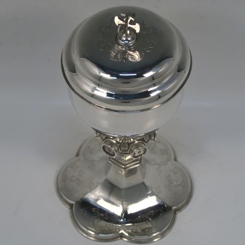 A beautiful Antique Victorian Sterling Silver Ciborium, having a plain round bellied body and a gold-gilt interior, sitting on a pedestal foot with a central applied jewel-like and floral baluster and a hand-engraved hexafoil foot with an applied bead-edged border, and a domed lift-off lid with cruciform finial and hand-engraved decoration. This wonderful silver ciborium was made by John Hardman and Co., of Birmingham in 1874. The dimensions of this fine hand-made antique silver ciborium are height 21.5 cms (8.5 inches), diameter of cup 9 cms (3.5 inches), and it weighs approx. 393g (12.6 troy ounces).