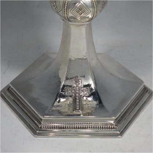 A Sterling Silver Chalice having a round body with a hand-hammered finish, a hexagonal pedestal foot with a central baluster, having applied bead borders, a gold-gilt interior, and a hand-chased crucifix. Made by Frederick Osbourne of London in 1933. The dimensions of this fine hand-made chalice are height 20 cms (8 inches), diameter at lip 10 cms (4 inches), and it weighs approx. 682g (22 troy ounces).
