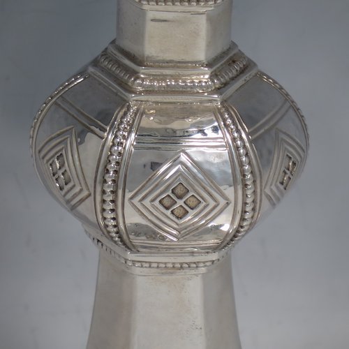 A Sterling Silver Chalice having a round body with a hand-hammered finish, a hexagonal pedestal foot with a central baluster, having applied bead borders, a gold-gilt interior, and a hand-chased crucifix. Made by Frederick Osbourne of London in 1933. The dimensions of this fine hand-made chalice are height 20 cms (8 inches), diameter at lip 10 cms (4 inches), and it weighs approx. 682g (22 troy ounces).