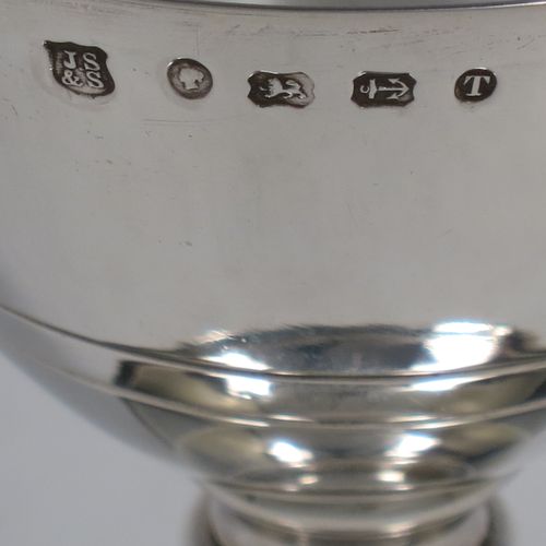 A handsome Antique Victorian Sterling Silver altar chalice and paten, having a plain round tapering cup, a middle plain round stepped baluster, sitting on a round stepped pedestal foot, and a matching plain round paten. Made by J. Sherwood and Sons of Birmingham in 1868. The dimensions of this fine hand-made antique silver chalice and paten are height of chalice 12.5 cms (5 inches), diameter of paten 11.5 cms (4.5 inches), and with a total weight of approx. 252g (8 troy ounces).