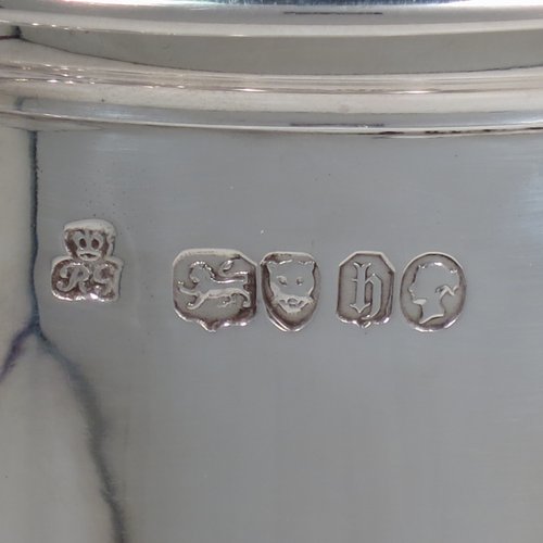 An Antique Victorian Sterling Silver communion service composed of a flagon and two goblets. The flagon in an early 17th century style having a straight-sided body, a scroll handle, a hinged & domed lid with urn-shaped finial, a matching scrolled spout and sitting on a collet foot. Together with a pair of plain round baluster goblets with gold-gilt interiors. All made by Robert Garrard of London in 1862/63. The dimensions of this fine hand-made communion set are height of flagon 29 cms (11.5 inches), length across handle & spout 23 cms (9 inches), height of goblets 18 cms (7 inches), and with a total weight of approx. 1,643g (53 troy ounces).