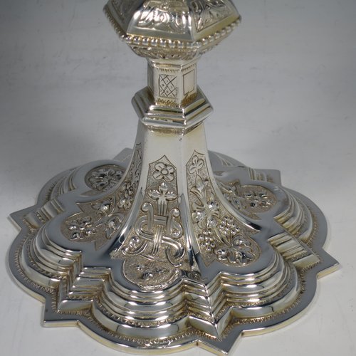 An Irish Sterling Silver altar chalice and paten, having a plain round tapering gold-gilt cup, a panelled column with a middle baluster, and a spreading pedestal foot, all hand-chased and engraved with floral & geometrical work, together with a plain round gold-gilt paten. Made by the same maker (J.S) of Dublin in 1935/39. The dimensions of this fine hand-made silver chalice & paten are height 23 cms (9 inches), diameter at base 13.5 cms (5.3 inches), and it weighs approx. 607g (19.6 troy ounces). Please note that there is an inscription under the base.