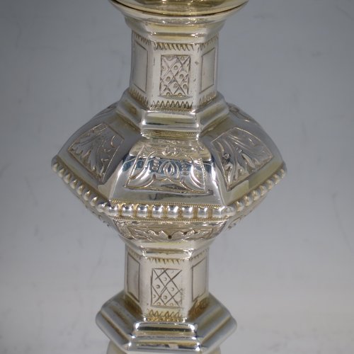 An Irish Sterling Silver altar chalice and paten, having a plain round tapering gold-gilt cup, a panelled column with a middle baluster, and a spreading pedestal foot, all hand-chased and engraved with floral & geometrical work, together with a plain round gold-gilt paten. Made by the same maker (J.S) of Dublin in 1935/39. The dimensions of this fine hand-made silver chalice & paten are height 23 cms (9 inches), diameter at base 13.5 cms (5.3 inches), and it weighs approx. 607g (19.6 troy ounces). Please note that there is an inscription under the base.