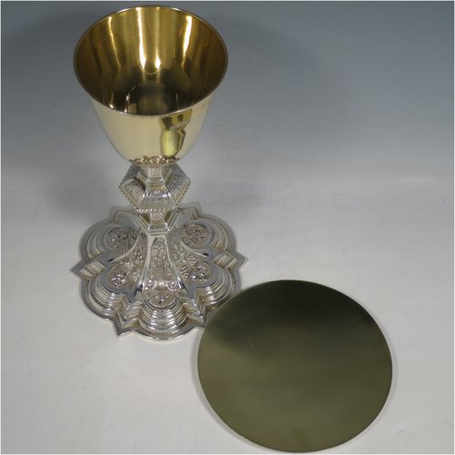 An Irish Sterling Silver altar chalice and paten, having a plain round tapering gold-gilt cup, a panelled column with a middle baluster, and a spreading pedestal foot, all hand-chased and engraved with floral & geometrical work, together with a plain round gold-gilt paten. Made by the same maker (J.S) of Dublin in 1935/39. The dimensions of this fine hand-made silver chalice & paten are height 23 cms (9 inches), diameter at base 13.5 cms (5.3 inches), and it weighs approx. 607g (19.6 troy ounces). Please note that there is an inscription under the base.