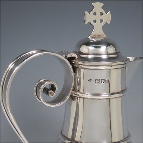 An Antique Edwardian Sterling Silver ecclesiastical wine / water flagon, having a plain baluster body with applied bands, together with a hinged domed lid with a Celtic style cross finial, a plain sparrow-beak spout, a scroll handle, and sitting on a spreading hexafoil foot. Made by Robert Stebbings of London in 1905. The dimensions of this fine hand-made antique silver flagon are height 31 cms (12.25 inches), length 16 cms (6.25 inches), and it weighs approx. 897g (29 troy ounces).