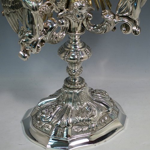 An Antique Victorian Sterling Silver and gold-gilt Belgian Monstrance, for holding the consecrated host, with crown finial above two cast cherub figures, a sun-burst relic Luna holder with two cast angel figures below, and sitting on a hand-chased oval shaped pedestal foot. Made by M. Decury of Belgium between 1831 and 1868. The dimensions of this fine hand-made antique silver Monstrance are height 71 cms (28 inches), depth 15 cms (6 inches), and width 33 cms (13 inches), with a total weight of approx. 97 troy ounces (3,000g).