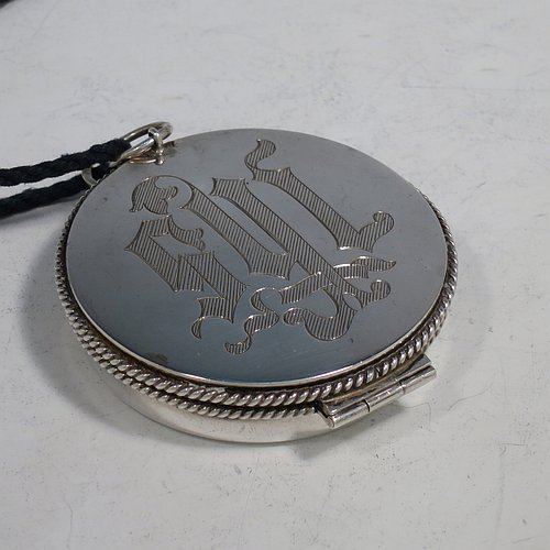 A Sterling Silver Pyx box, having a plain round body with applied rope-twist borders, a hinged lid with a hand-engraved Christogram, a gold-gilt interior, and with a pair of ring handles. Made by B. O. & W. Ltd., of London in 1925. The dimensions of this fine hand-made silver Pyx box are diameter 6 cms (2.3 inches), depth 2 cms (0.5 inches), and it weighs approx. 48g (1.5 troy ounces).    