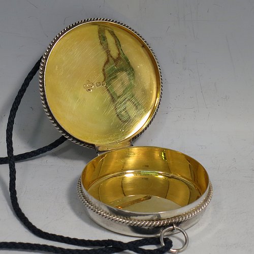 A Sterling Silver Pyx box, having a plain round body with applied rope-twist borders, a hinged lid with a hand-engraved Christogram, a gold-gilt interior, and with a pair of ring handles. Made by B. O. & W. Ltd., of London in 1925. The dimensions of this fine hand-made silver Pyx box are diameter 6 cms (2.3 inches), depth 2 cms (0.5 inches), and it weighs approx. 48g (1.5 troy ounces).