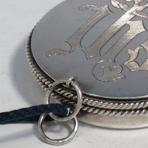 A Sterling Silver Pyx box, having a plain round body with applied rope-twist borders, a hinged lid with a hand-engraved Christogram, a gold-gilt interior, and with a pair of ring handles. Made by B. O. & W. Ltd., of London in 1925. The dimensions of this fine hand-made silver Pyx box are diameter 6 cms (2.3 inches), depth 2 cms (0.5 inches), and it weighs approx. 48g (1.5 troy ounces).