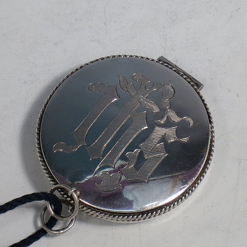 A Sterling Silver Pyx box, having a plain round body with applied rope-twist borders, a hinged lid with a hand-engraved Christogram, a gold-gilt interior, and with a pair of ring handles. Made by B. O. & W. Ltd., of London in 1925. The dimensions of this fine hand-made silver Pyx box are diameter 6 cms (2.3 inches), depth 2 cms (0.5 inches), and it weighs approx. 48g (1.5 troy ounces).