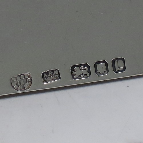 A Sterling Silver wafer box, having a plain rectangular body with rounded corners, a lift-off lid with a hand-engraved Christogram, covering a holder with five slots for wafers, and sitting on an applied base with four ball feet. Made by A. R. Mowbray & Co. Ltd., of London in 1946. The dimensions of this fine hand-made silver wafer box are length 9.5 cms (3.75 inches), depth 6 cms (2.25 inches), height 4.5 cms (1.75 inches), and it weighs approx. 211g (6.8 troy ounces).