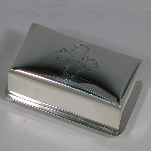 A Sterling Silver wafer box, having a plain rectangular body with rounded corners, a lift-off lid with a hand-engraved Christogram, covering a holder with five slots for wafers, and sitting on an applied base with four ball feet. Made by A. R. Mowbray & Co. Ltd., of London in 1946. The dimensions of this fine hand-made silver wafer box are length 9.5 cms (3.75 inches), depth 6 cms (2.25 inches), height 4.5 cms (1.75 inches), and it weighs approx. 211g (6.8 troy ounces).