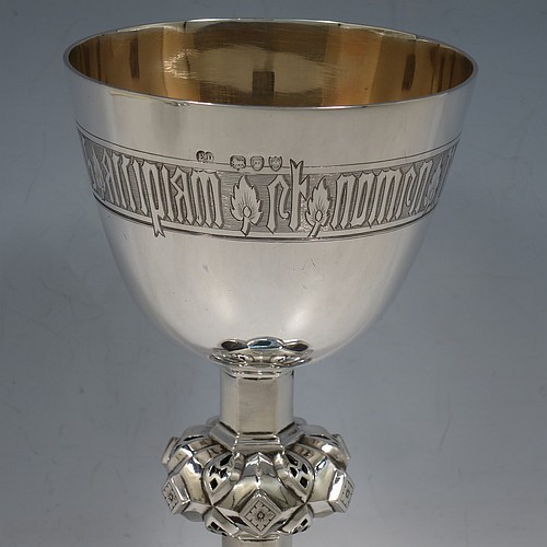 An Antique Victorian Sterling Silver pair of altar chalices, having plain round tapering cups with gold-gilt interiors and bands of hand-engraved Latin inscriptions, middle balusters with hand-chased work made to look as if mounted with six jewels, and sitting on spreading hexafoil feet with engraved Christograms. Made by Edward Dimes of London in 1893. The dimensions of this fine pair of hand-made antique silver chalices are height 20 cms (8 inches), width at base 13 cms (5 inches), and they weigh a total of approx. 778g (25 troy ounces).