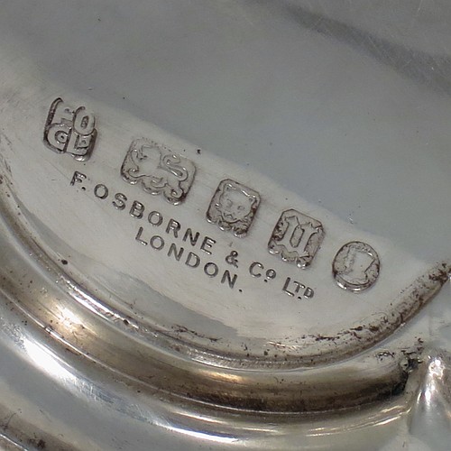 A Sterling Silver altar chalice and paten, having a plain round tapering cup, a middle baluster with hand-chased floral work made to look as if mounted with six jewels, and a spreading hexa-foil foot, with applied rope-twist borders, together with an original plain round paten. Made by Frederick Osborne and Co., of London in 1934. The dimensions of this fine hand-made silver chalice & paten are height 20 cms (8 inches), width at base 14 cms (5.5 inches), and it weighs approx. 659g (21 troy ounces).