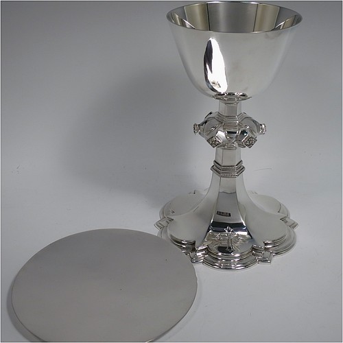 A Sterling Silver altar chalice and paten, having a plain round tapering cup, a middle baluster with hand-chased floral work made to look as if mounted with six jewels, and a spreading hexa-foil foot, with applied rope-twist borders, together with an original plain round paten. Made by Frederick Osborne and Co., of London in 1934. The dimensions of this fine hand-made silver chalice & paten are height 20 cms (8 inches), width at base 14 cms (5.5 inches), and it weighs approx. 659g (21 troy ounces).