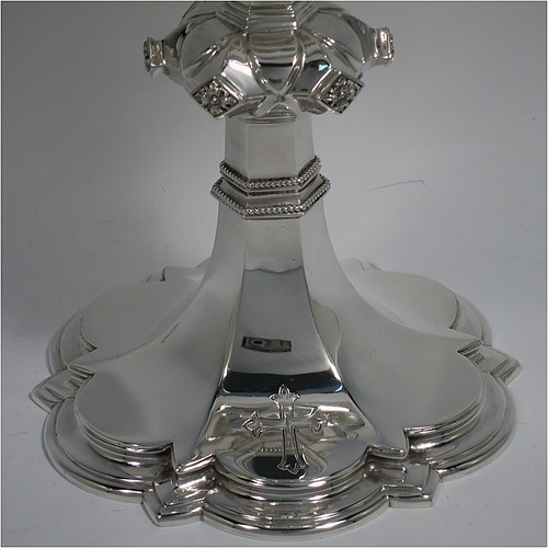 A Sterling Silver altar chalice and paten, having a plain round tapering cup, a middle baluster with hand-chased floral work made to look as if mounted with six jewels, and a spreading hexa-foil foot, with applied rope-twist borders, together with an original plain round paten. Made by Frederick Osborne and Co., of London in 1934. The dimensions of this fine hand-made silver chalice & paten are height 20 cms (8 inches), width at base 14 cms (5.5 inches), and it weighs approx. 659g (21 troy ounces).