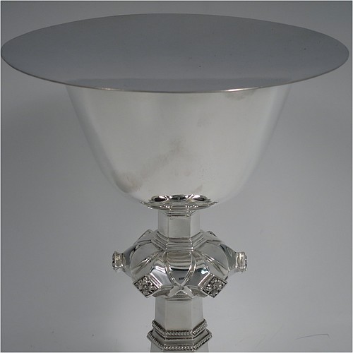 A Sterling Silver altar chalice and paten, having a plain round tapering cup, a middle baluster with hand-chased floral work made to look as if mounted with six jewels, and a spreading hexa-foil foot, with applied rope-twist borders, together with an original plain round paten. Made by Frederick Osborne and Co., of London in 1934. The dimensions of this fine hand-made silver chalice & paten are height 20 cms (8 inches), width at base 14 cms (5.5 inches), and it weighs approx. 659g (21 troy ounces).