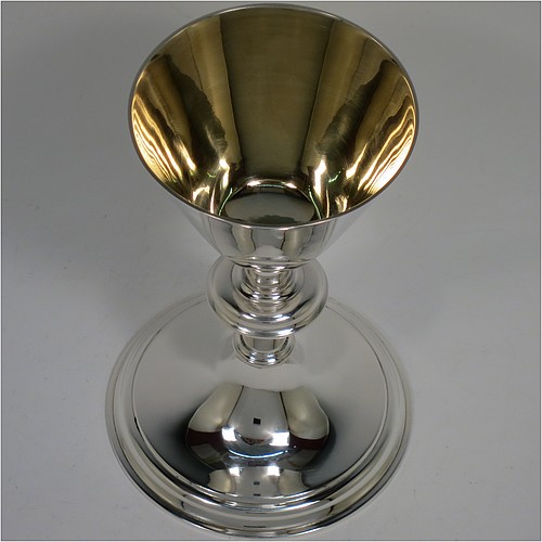 An Antique Victorian Sterling Silver altar chalice, having a plain round tapering cup with a gold-gilt interior, a round plain column with a middle baluster, and a spreading round pedestal foot with reeded border. Made by Blunt, Wray and Co., of London in 1897. The dimensions of this fine hand-made antique silver chalice are height 13 cms (5 inches), diameter of cup 8 cms (3.25 inches), and it weighs approx. 235g (7.6 troy ounces).