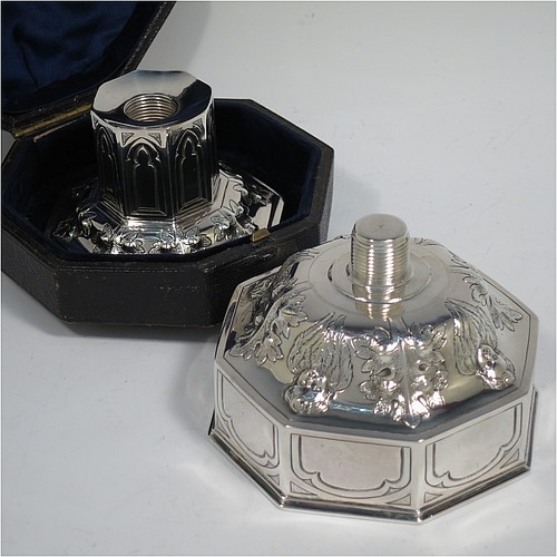 An Antique Victorian Sterling Silver very rare and unusual travelling chalice, in the shape of an octagonal shaped baptismal font, the top piece, which screws into the base, having a gold-gilt interior and hand-chased panels with anthemion leaves and angel faces, the pedestal base with matching panel work and leaves, and all in its original dark-blue satin and velvet-lined presentation box. Made by George Fox of London in 1863. The dimensions of this fine hand-made antique silver travelling chalice are height 10 cms (4 inches), diameter at top 9 cms (3.5 inches), with a total weight of approx. 172g (5.5 troy ounces).