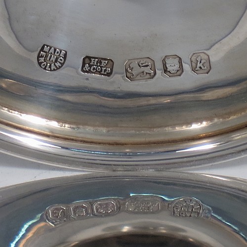 A small Sterling Silver altar chalice and paten, having a plain round bellied cup, a round column with a middle baluster, and a spreading round pedestal foot with reeded borders, together with a plain round original paten. Made by H. F. and Co. Ltd. of London in 1965. The dimensions of this fine hand-made silver chalice and paten are height 10 cms (4 inches), diameter of paten 11 cms (4.25 inches), with a total weight of approx. 203g (6.5 troy ounces).