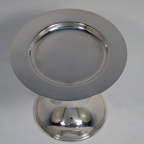 A small Sterling Silver altar chalice and paten, having a plain round bellied cup, a round column with a middle baluster, and a spreading round pedestal foot with reeded borders, together with a plain round original paten. Made by H. F. and Co. Ltd. of London in 1965. The dimensions of this fine hand-made silver chalice and paten are height 10 cms (4 inches), diameter of paten 11 cms (4.25 inches), with a total weight of approx. 203g (6.5 troy ounces).