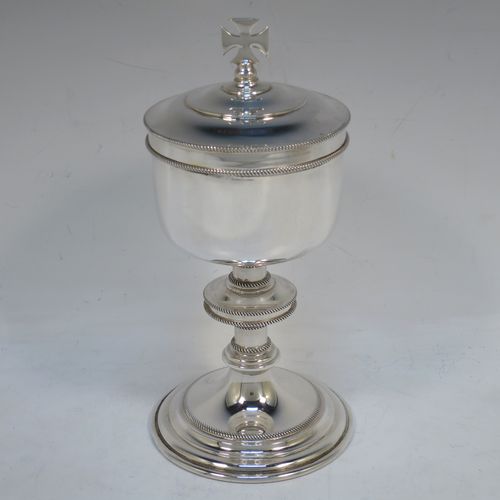 A handsome Sterling Silver Ciborium, having a plain round body with applied rope-twist borders and a gold-gilt interior, sitting on a matching pedestal foot with central baluster, and a lift-off lid with cruciform finial. Made by Vanpoulles Ltd. of London in 1962. The dimensions of this fine hand-made silver ciborium are height 19 cms (7.5 inches), diameter of cup 8.5 cms (3.3 inches), and the cup weighs approx. 264g (8.5 troy ounces).  