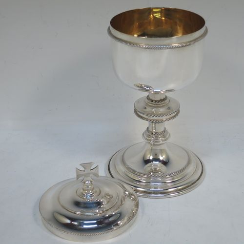 A handsome Sterling Silver Ciborium, having a plain round body with applied rope-twist borders and a gold-gilt interior, sitting on a matching pedestal foot with central baluster, and a lift-off lid with cruciform finial. Made by Vanpoulles Ltd. of London in 1962. The dimensions of this fine hand-made silver ciborium are height 19 cms (7.5 inches), diameter of cup 8.5 cms (3.3 inches), and the cup weighs approx. 264g (8.5 troy ounces).