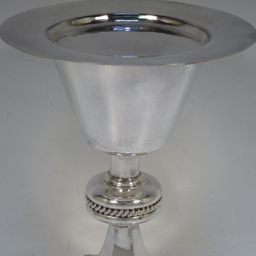 A very handsome Sterling Silver altar chalice and paten, having a round hand-hammered tapering cup with a gold-gilt interior, a middle baluster with an applied gadroon band, and a spreading hexagonal pedestal foot with applied double gadroon borders, and the paten with matching hand-hammered decoration. Made by Hurst, Franklin and Co. Ltd., of London in 1956. The dimensions of this fine hand-made silver chalice and paten are height 20 cms (8 inches), width at base 13.5 cms (5.5 inches), diameter of paten 15 cms (6 inches), and it weighs approx. 326g (10.5 troy ounces).