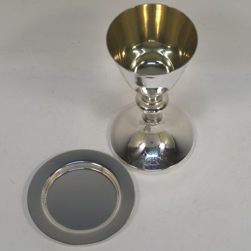 A handsome Sterling Silver altar chalice and paten, having a plain round tapering cup with a gold-gilt interior, a middle plain round baluster, sitting on a round pedestal foot, and a matching plain round paten. This beautiful silver chalice and paten were made by A. E. Jones of Birmingham in 1962. The dimensions of this fine hand-made silver chalice and paten are height of chalice 15 cms (6 inches), diameter of paten 10 cms (4 inches), and with a total weight of approx. 251g (8 troy ounces).   