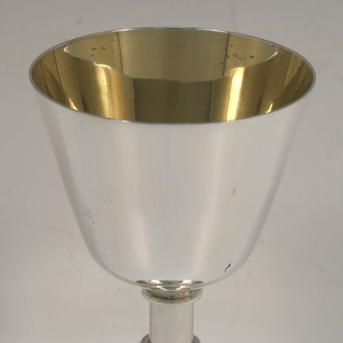 A handsome Sterling Silver altar chalice and paten, having a plain round tapering cup with a gold-gilt interior, a middle plain round baluster, sitting on a round pedestal foot, and a matching plain round paten. This beautiful silver chalice and paten were made by A. E. Jones of Birmingham in 1962. The dimensions of this fine hand-made silver chalice and paten are height of chalice 15 cms (6 inches), diameter of paten 10 cms (4 inches), and with a total weight of approx. 251g (8 troy ounces).   