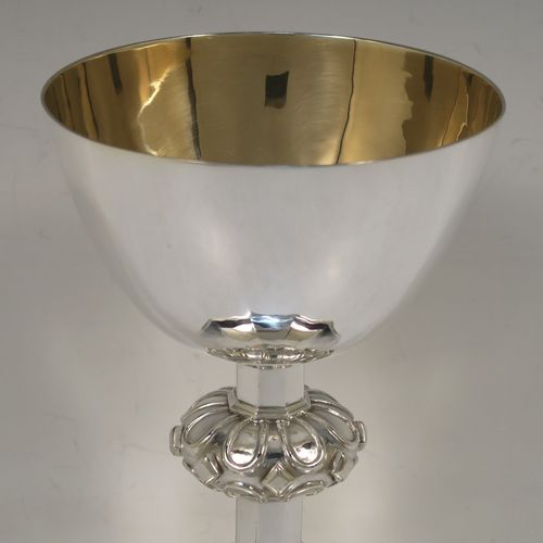 A very handsome Sterling Silver altar chalice and paten, having a round tapering cup with a gold-gilt interior, a middle baluster with applied jewel and band decoration, and a spreading hexagonal pedestal foot, together with an original plain round paten. This elegant silver chalice and paten was made by William F. Knight Ltd., of London in 1953. The dimensions of this fine hand-made silver chalice and paten are height 19 cms (7.5 inches), diameter of paten 15.5 cms (6 inches), and it weighs approx. 705g (22.5 troy ounces).
