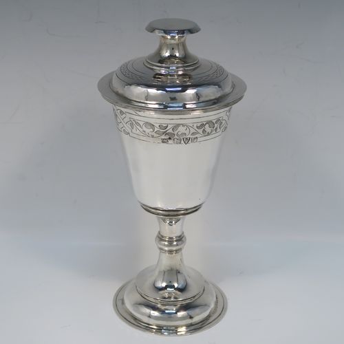 A very handsome Antique Sterling Silver altar chalice and cover, in a post-Reformation communion cup style, having a plain round tapering cup with a top band of floral hand-engraved decoration, a lift-off lid with flat finial, all sitting on a round stepped pedestal foot with a middle baluster. This beautiful silver chalice cup and cover were made by Herbert and Frank Barker of Chester in 1915. The dimensions of this fine hand-made silver communion cup and cover are height 21 cms (8.25 inches), diameter 9 cms (3.5 inches), and with a total weight of approx. 343g (11 troy ounces).   