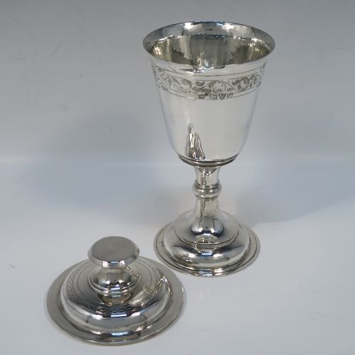 A very handsome Antique Sterling Silver altar chalice and cover, in a post-Reformation communion cup style, having a plain round tapering cup with a top band of floral hand-engraved decoration, a lift-off lid with flat finial, all sitting on a round stepped pedestal foot with a middle baluster. This beautiful silver chalice cup and cover were made by Herbert and Frank Barker of Chester in 1915. The dimensions of this fine hand-made silver communion cup and cover are height 21 cms (8.25 inches), diameter 9 cms (3.5 inches), and with a total weight of approx. 343g (11 troy ounces).   