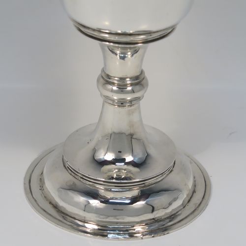 A very handsome Antique Sterling Silver altar chalice and cover, in a post-Reformation communion cup style, having a plain round tapering cup with a top band of floral hand-engraved decoration, a lift-off lid with flat finial, all sitting on a round stepped pedestal foot with a middle baluster. This beautiful silver chalice cup and cover were made by Herbert and Frank Barker of Chester in 1915. The dimensions of this fine hand-made silver communion cup and cover are height 21 cms (8.25 inches), diameter 9 cms (3.5 inches), and with a total weight of approx. 343g (11 troy ounces).   