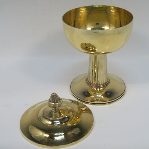A very beautiful and stylish Sterling Silver and Gold-Gilt Ciborium, having a round body with a hand-hammered or planished finish, sitting on a round pedestal foot base with a hand-chased and panelled column, and a lift-off lid with urn-shaped finial. This beautiful Arts and Crafts style silver ciborium was made by George Hart for the Guild of Handicrafts in London 1953. The dimensions of this fine hand-made silver and gold-gilt ciborium are height 19 cms (7.5 inches), diameter of cup 11.5 cms (4.5 inches), and it weighs a total of approx. 620g (20 troy ounces).   