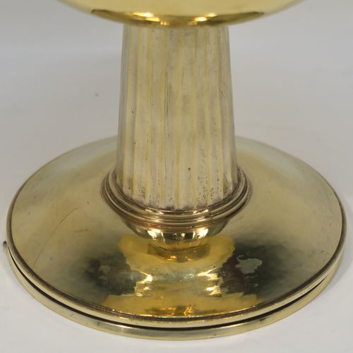 A very beautiful and stylish Sterling Silver and Gold-Gilt Ciborium, having a round body with a hand-hammered or planished finish, sitting on a round pedestal foot base with a hand-chased and panelled column, and a lift-off lid with urn-shaped finial. This beautiful Arts and Crafts style silver ciborium was made by George Hart for the Guild of Handicrafts in London 1953. The dimensions of this fine hand-made silver and gold-gilt ciborium are height 19 cms (7.5 inches), diameter of cup 11.5 cms (4.5 inches), and it weighs a total of approx. 620g (20 troy ounces).   