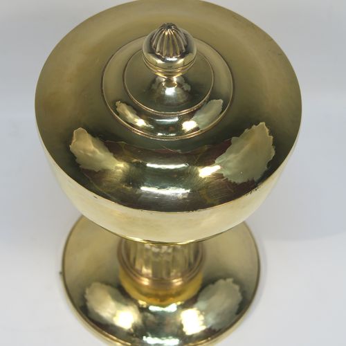 A very beautiful and stylish Sterling Silver and Gold-Gilt Ciborium, having a round body with a hand-hammered or planished finish, sitting on a round pedestal foot base with a hand-chased and panelled column, and a lift-off lid with urn-shaped finial. This beautiful Arts and Crafts style silver ciborium was made by George Hart for the Guild of Handicrafts in London 1953. The dimensions of this fine hand-made silver and gold-gilt ciborium are height 19 cms (7.5 inches), diameter of cup 11.5 cms (4.5 inches), and it weighs a total of approx. 620g (20 troy ounces).   