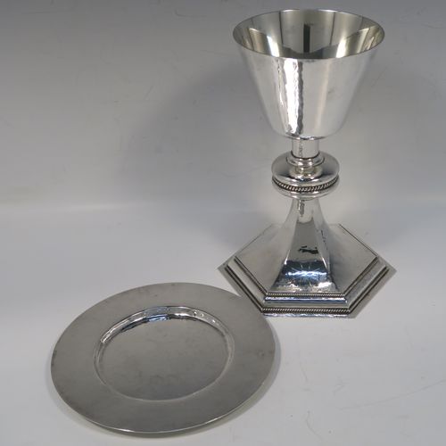 A very handsome Sterling Silver altar chalice and paten, having a round hand-hammered tapering cup with a gold-gilt interior, a middle baluster with an applied rope-twist band, and a spreading hexagonal pedestal foot with applied double rope-twist borders, and the paten with matching hand-hammered decoration. This beautiful silver chalice and paten was made by Hurst, Franklin and Co. Ltd., of London in 1959 (chalice) and 1965 (paten). The dimensions of this fine hand-made silver chalice and paten are height 19.5 cms (7.75 inches), width at base 14 cms (5.5 inches), diameter of paten 15 cms (6 inches), and it weighs approx. 560g (18 troy ounces).