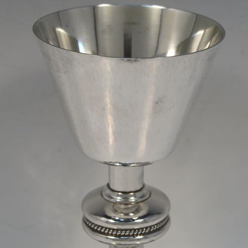 A very handsome Sterling Silver altar chalice and paten, having a round hand-hammered tapering cup with a gold-gilt interior, a middle baluster with an applied rope-twist band, and a spreading hexagonal pedestal foot with applied double rope-twist borders, and the paten with matching hand-hammered decoration. This beautiful silver chalice and paten was made by Hurst, Franklin and Co. Ltd., of London in 1959 (chalice) and 1965 (paten). The dimensions of this fine hand-made silver chalice and paten are height 19.5 cms (7.75 inches), width at base 14 cms (5.5 inches), diameter of paten 15 cms (6 inches), and it weighs approx. 560g (18 troy ounces).