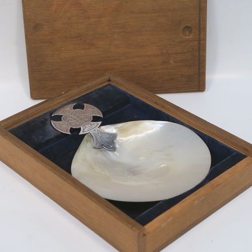 A large and very pretty Antique Sterling Silver and Mother-of-Pearl Anointing or Baptismal holy water Shell, having a silver handle pinned to a shell scoop, with a wonderfully hand-engraved Christoform style handle, and comes with a dark blue velvet-lined wooden presentation box. This beautiful baptism or anointing shell was made by J. Wippell and Co. Ltd., of London in 1921. The dimensions of this fine hand-made Baptism or Anointing Shell are length 18 cms (7 inches), and width 13 cms (5 inches). Please note that there is a small area of damage to the mother-of-pearl on the reverse side.