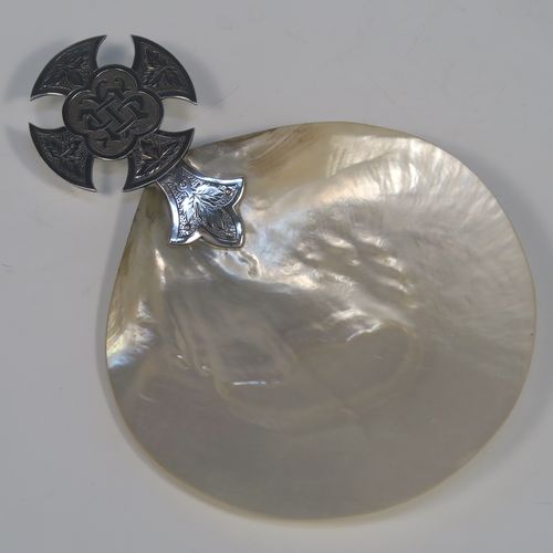 A large and very pretty Antique Sterling Silver and Mother-of-Pearl Anointing or Baptismal holy water Shell, having a silver handle pinned to a shell scoop, with a wonderfully hand-engraved Christoform style handle, and comes with a dark blue velvet-lined wooden presentation box. This beautiful baptism or anointing shell was made by J. Wippell and Co. Ltd., of London in 1921. The dimensions of this fine hand-made Baptism or Anointing Shell are length 18 cms (7 inches), and width 13 cms (5 inches). Please note that there is a small area of damage to the mother-of-pearl on the reverse side.