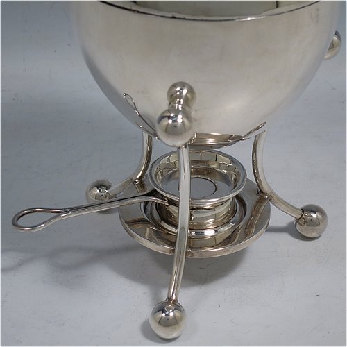 A rare Antique Edwardian Sterling Silver egg coddler, having a plain round body, with lift-off lid and wooden finial, sitting in a wire-work frame with ball terminals, an interior egg-holder for four eggs, and an original burner, all sitting on four ball feet. Made by Mappin & Webb of Sheffield in 1907. The dimensions of this fine hand-made antique silver egg coddler are height 23 cms (9 inches), diameter 11 cms (4.3 inches), and it weighs approx. 510g (16.5 troy ounces).