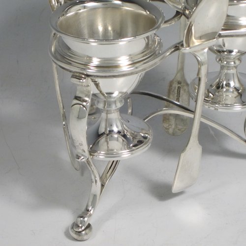 Antique Victorian sterling silver egg cruet set, having three removable plain round egg cups, and loop handle, all in a frame stand sitting on three scroll cushioned feet. The silver stand and egg cups are all made by Samuel Whitford of London in 1839, whilst the four spoons are in silver-plate. The dimensions of this fine hand-made silver egg cruet set are height 20 cms (8 inches), width 13.5 cms (5.3 inches), with a total weight of approx. 381g (12.3 troy ounces).