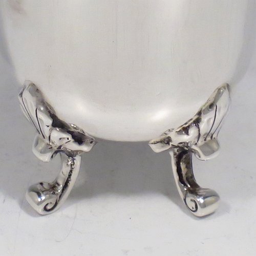 An Antique Edwardian Sterling Silver egg cup, having a plain round body with tapering sides, sitting on four cast foliate feet. Made by Charles Clement Pilling of Sheffield in 1907. The dimensions of this fine hand-made silver egg cup are height 5 cms (2 inches), diameter 4.5 cms (1.75 inches), and it weighs approx. 50g (1.6 troy ounces).